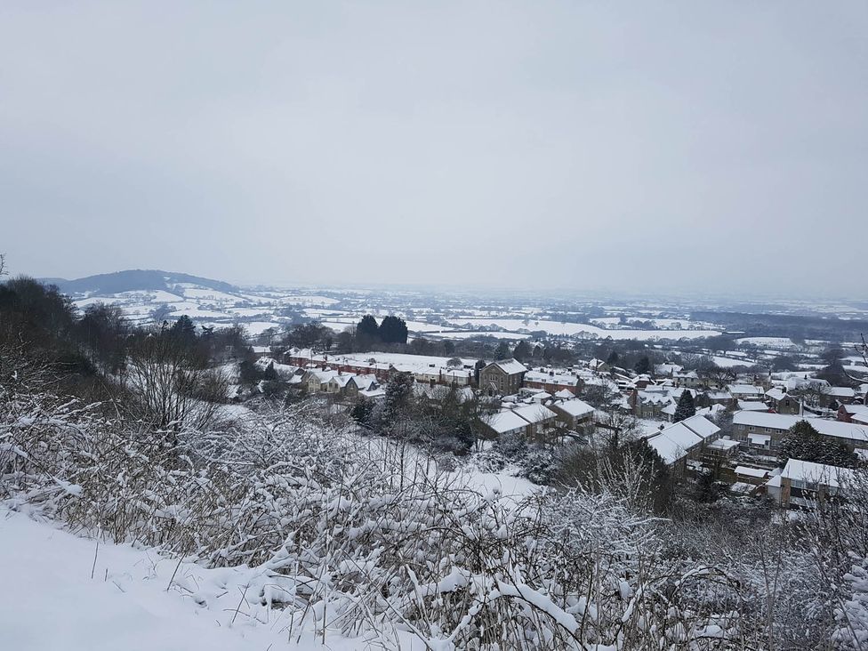 A view of houses and hills covered in snow