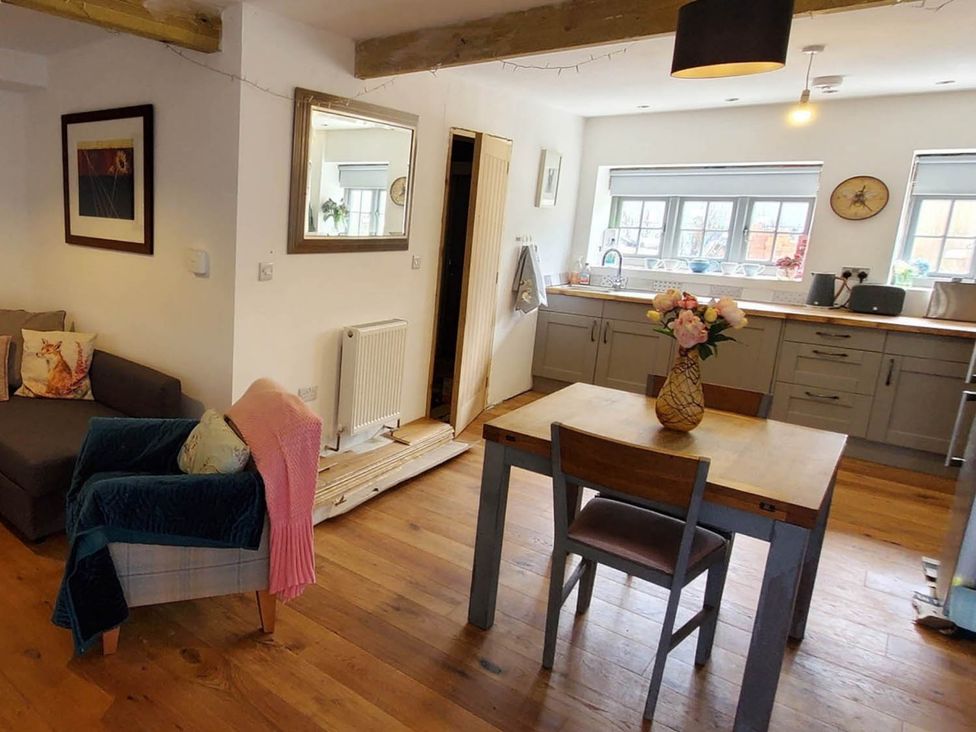 A living room with a sofa and dining table at 3 Bedroom Cottage Hot Tub Garden Parking Dunkeswell