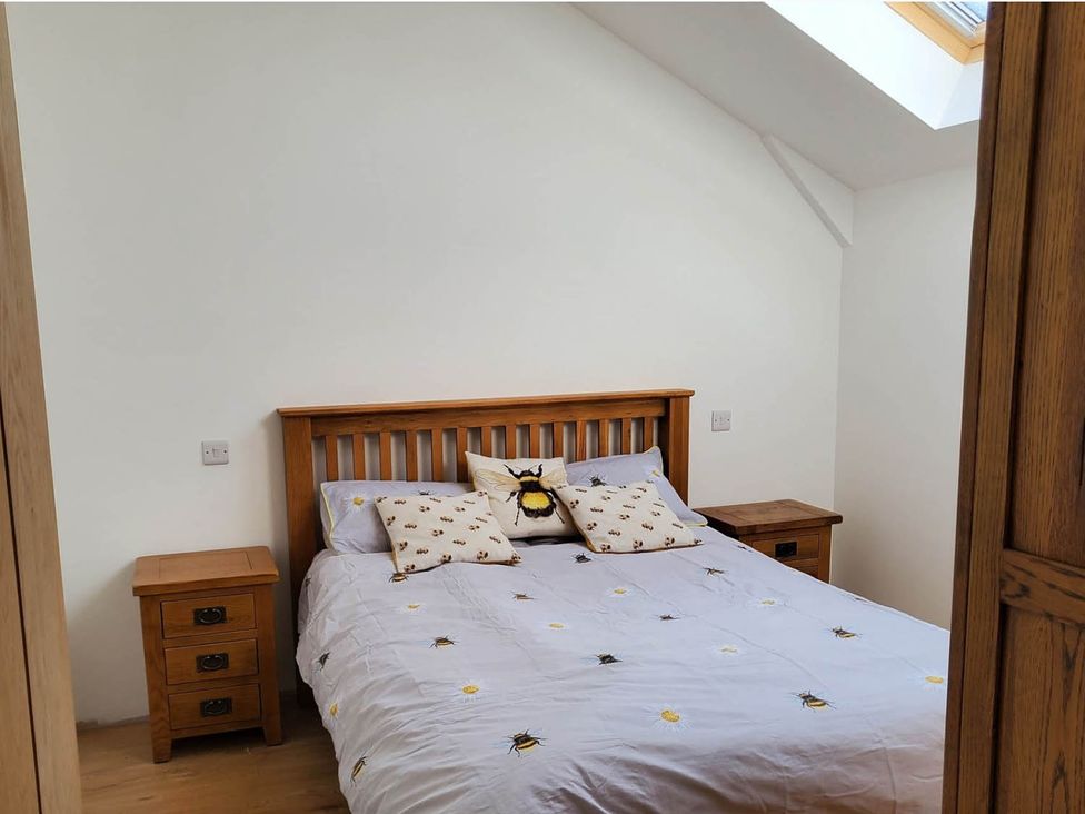 A bedroom with a bed and nightstands at 3 Bedroom Cottage Hot Tub Garden Parking Dunkeswell