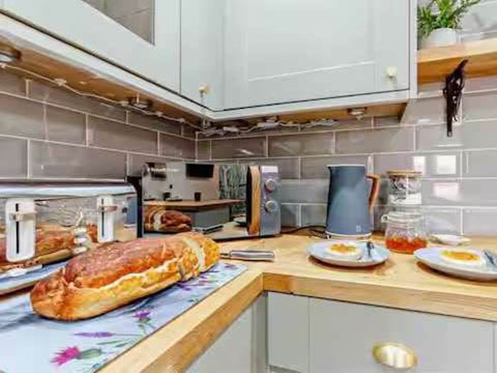 A kitchen with kitchen appliances and food items at The Old Barn in Forth