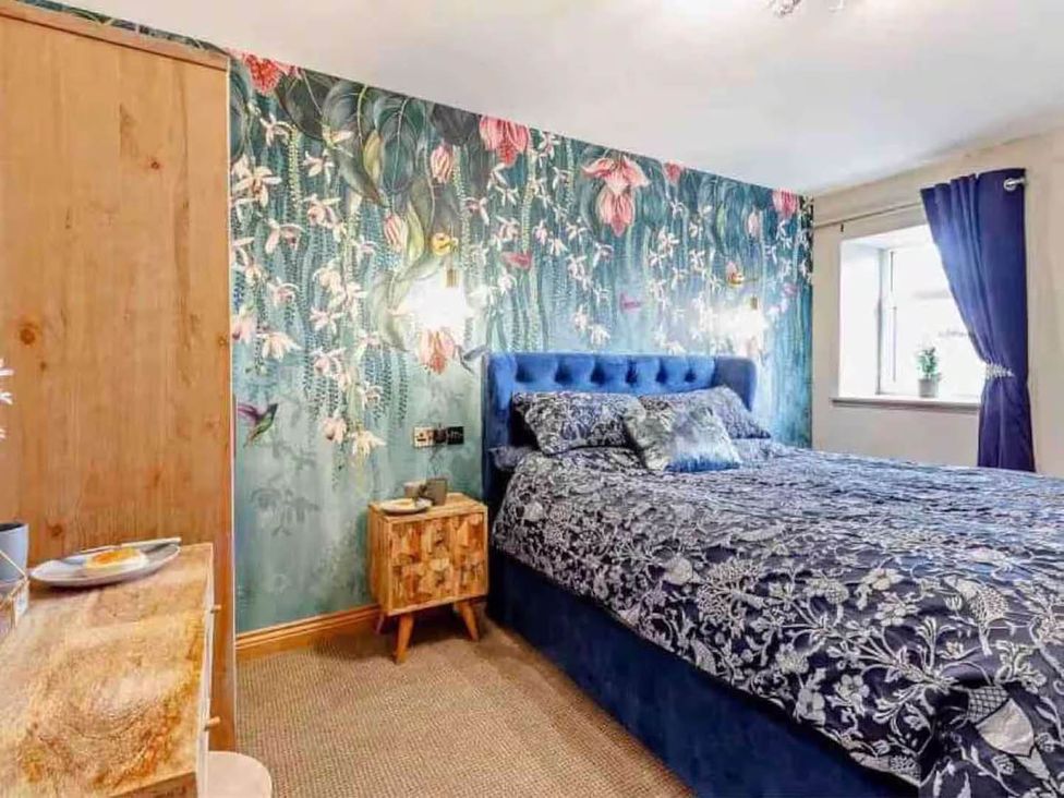 A bedroom with a bed and wardrobe at The Old Barn in Forth