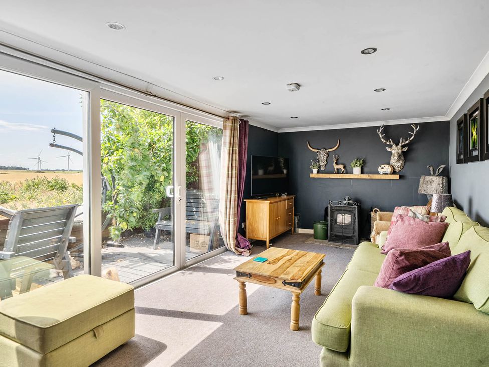 A living room with a sofa, coffee table and television at an unspecified location