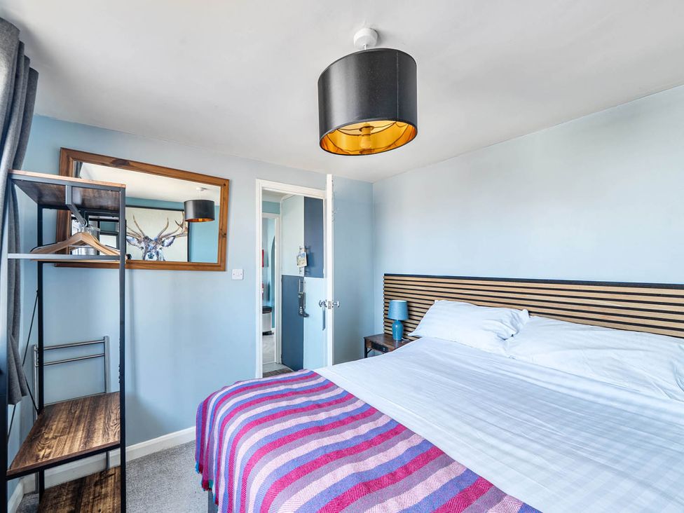 A bedroom with a bed and shelf at the property in location