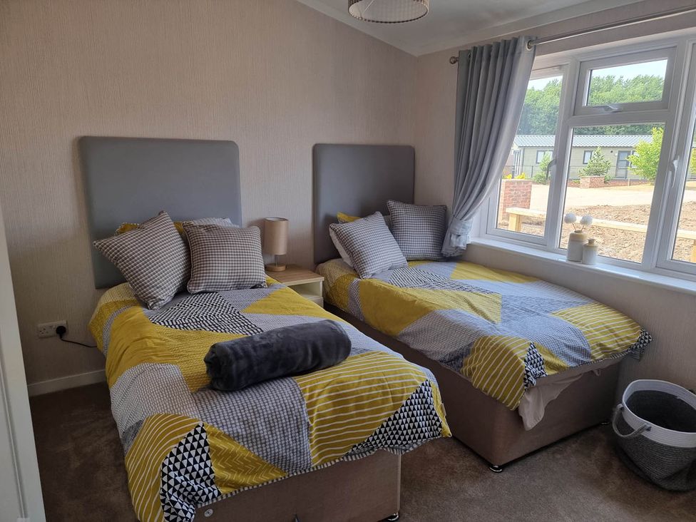 A bedroom with two beds and a window at Pet Friendly 2Bed Luxury Lodge in Routh HotTub near Heron Lakes Luxury Lodge Park