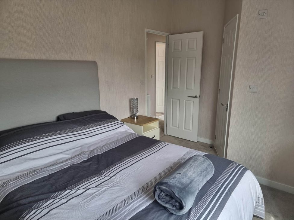 A bedroom with a bed and nightstand at Pet Friendly 2Bed Luxury Lodge in Routh HotTub near Heron Lakes Luxury Lodge Park