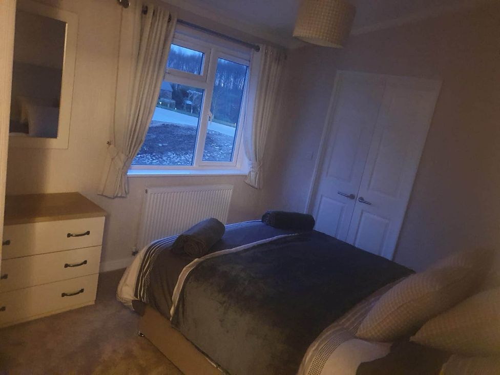 A bedroom with a bed and dresser at Pet Friendly 2Bed Luxury Lodge in Routh HotTub near Beverley