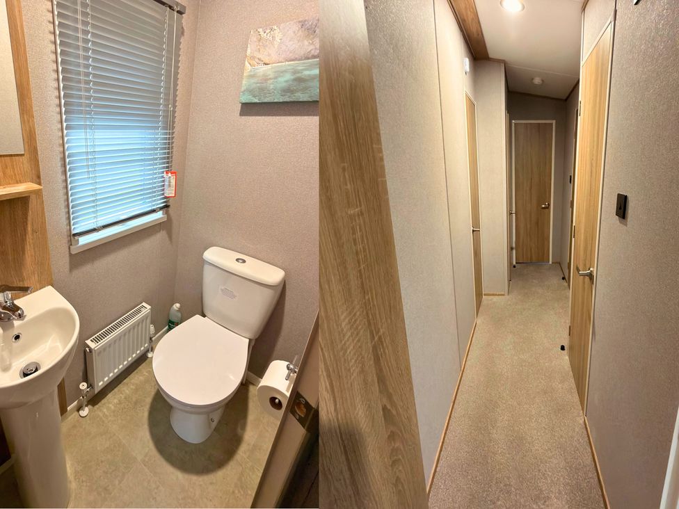 A bathroom featuring a toilet, sink, and radiator at Vintage 121 Southview Holiday Park Skegness