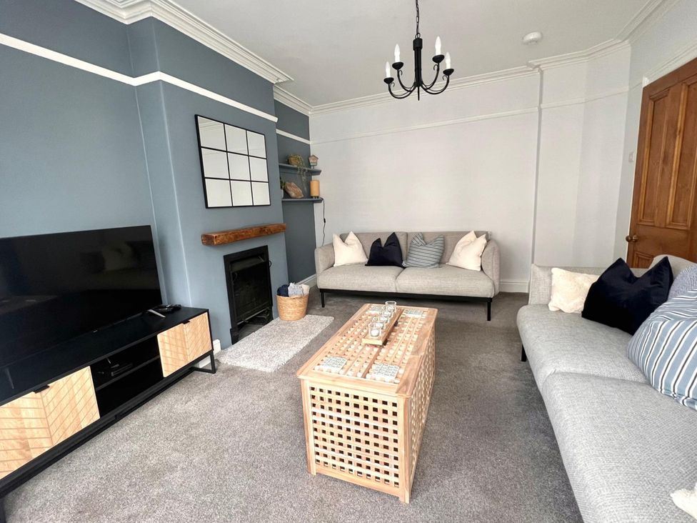 A living room with a sofa and coffee table at 4 Bed House Sleeps 8 Garden Pets Near Beach Llandudno