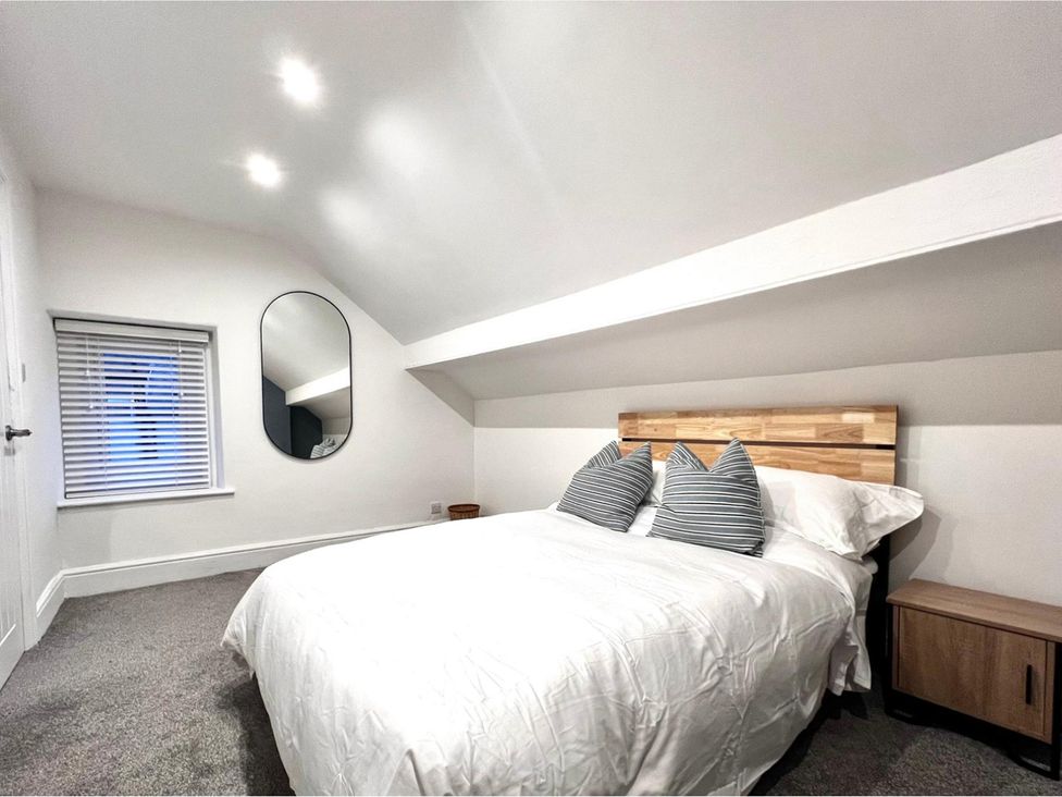 A bedroom with a bed and window at 4 Bed House Sleeps 8 Garden Pets Near Beach Llandudno
