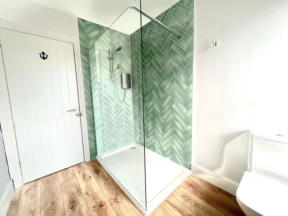 A bathroom with shower and toilet at 4 Bed House Sleeps 8 Garden Pets Near Beach Llandudno