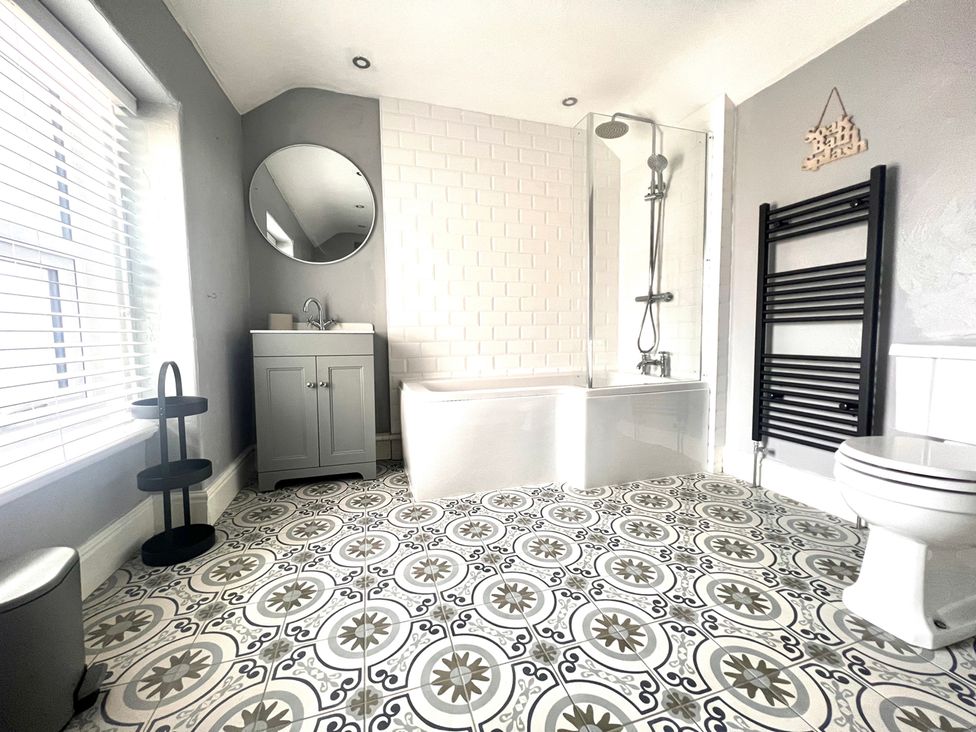 A bathroom with shower and bathtub at 4 Bed House Sleeps 8 Garden Pets Near Beach Llandudno