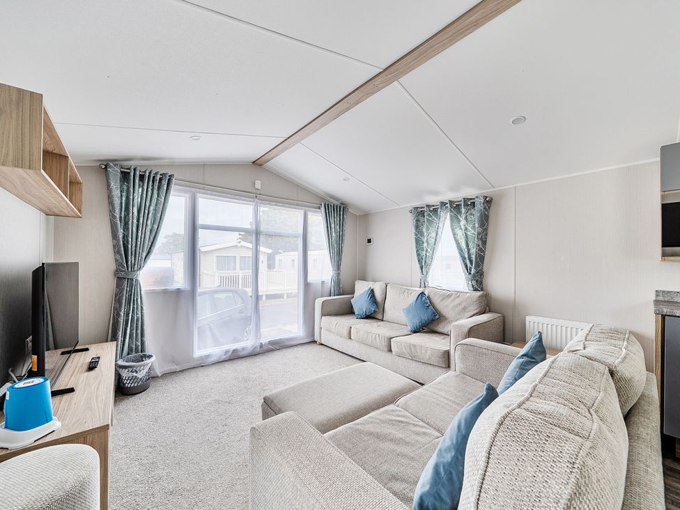 A living room with a sofa and television at Primrose Valley 3Bed Caravan Sleeps 8 Pets Ok, Primrose Valley