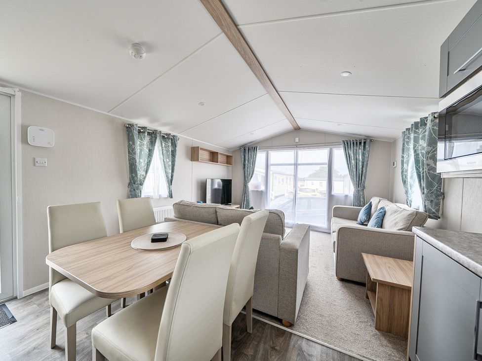 A living room with a table and chairs at Primrose Valley 3Bed Caravan Sleeps 8 Pets Ok Primrose Valley