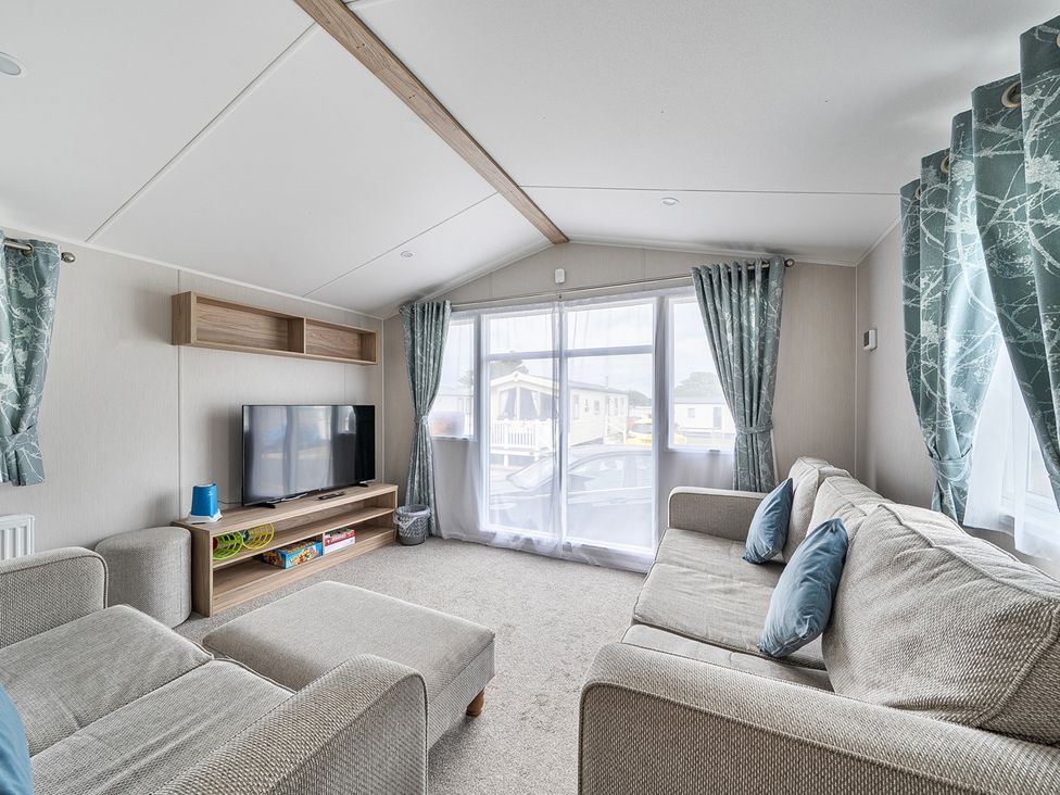 A living room with a sofa and television at Primrose Valley 3Bed Caravan Sleeps 8 Pets Ok Primrose Valley