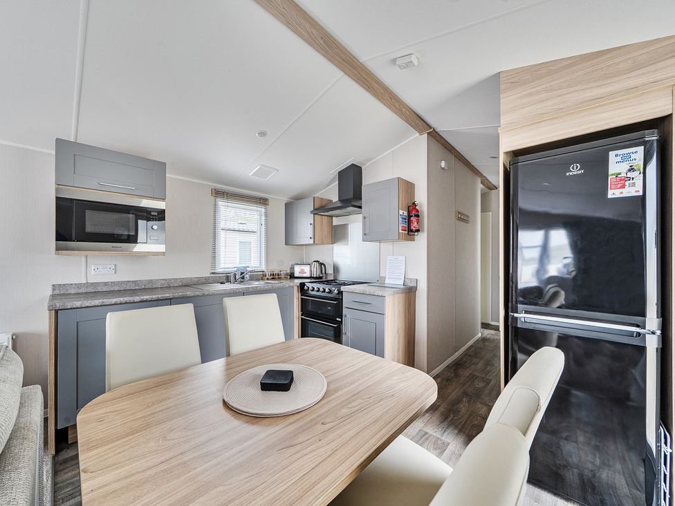 A kitchen with modern appliances and a dining area at Primrose Valley 3Bed Caravan Sleeps 8 Pets Ok, Primrose Valley
