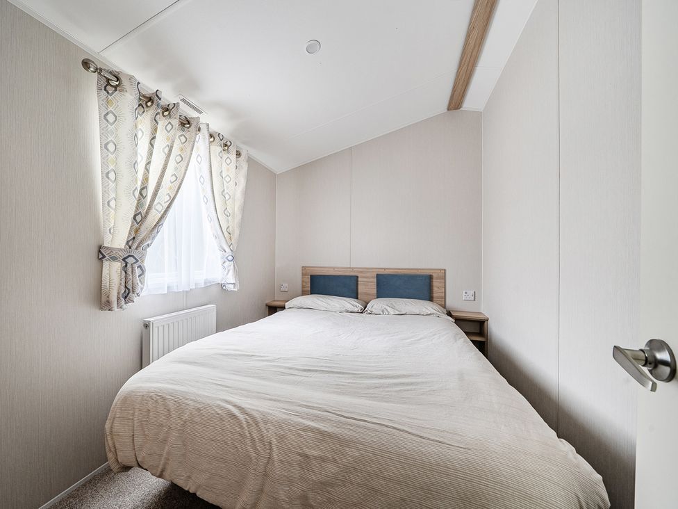 A bedroom with a bed and window at Primrose Valley 3Bed Caravan Sleeps 8 Pets Ok Primrose Valley