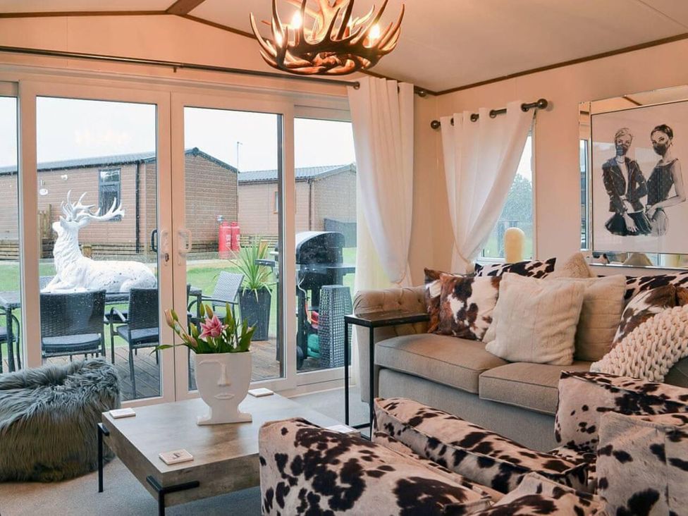A living room with a sofa and coffee table at Boutique lodge with hot tub sleeps 6 in Bridlington