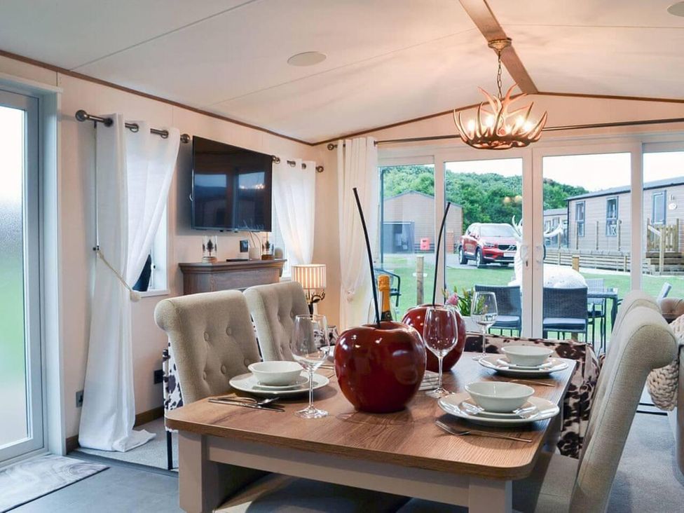 A dining room with a table and chairs at Boutique lodge with hot tub sleeps 6 Bridlington