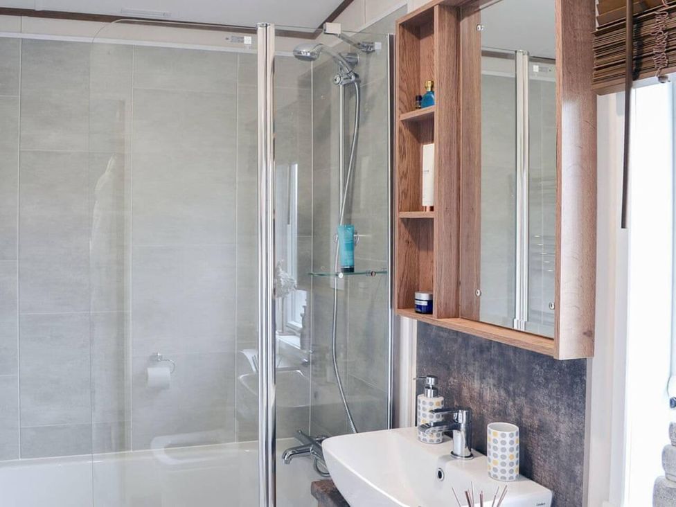 A bathroom with a shower and sink at Boutique lodge with hot tub sleeps 6 in Bridlington
