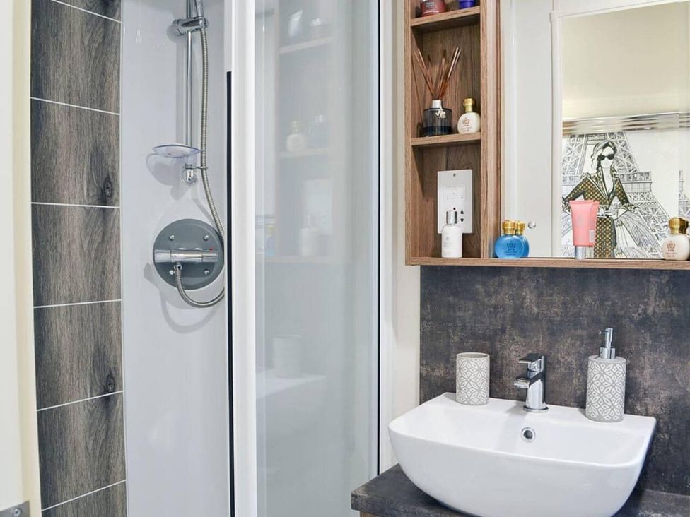 A bathroom with a shower and sink at Boutique lodge with hot tub sleeps 6 in Bridlington
