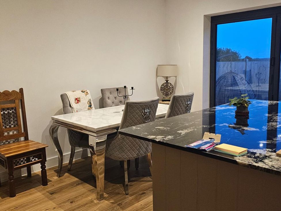 A dining room with a table and chairs at 5 Bed Sleeps 7 New Build Detached Property in Monkton near Minster