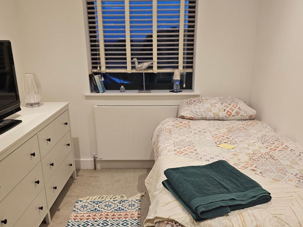 A bedroom with a bed and television in 5 Bed Sleeps 7 New Build Detached Property Monkton near Minster
