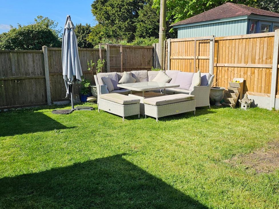 A garden with an outdoor sofa and coffee table at 5 Bed Sleeps 7 New Build Detached Property, Monkton near Minster