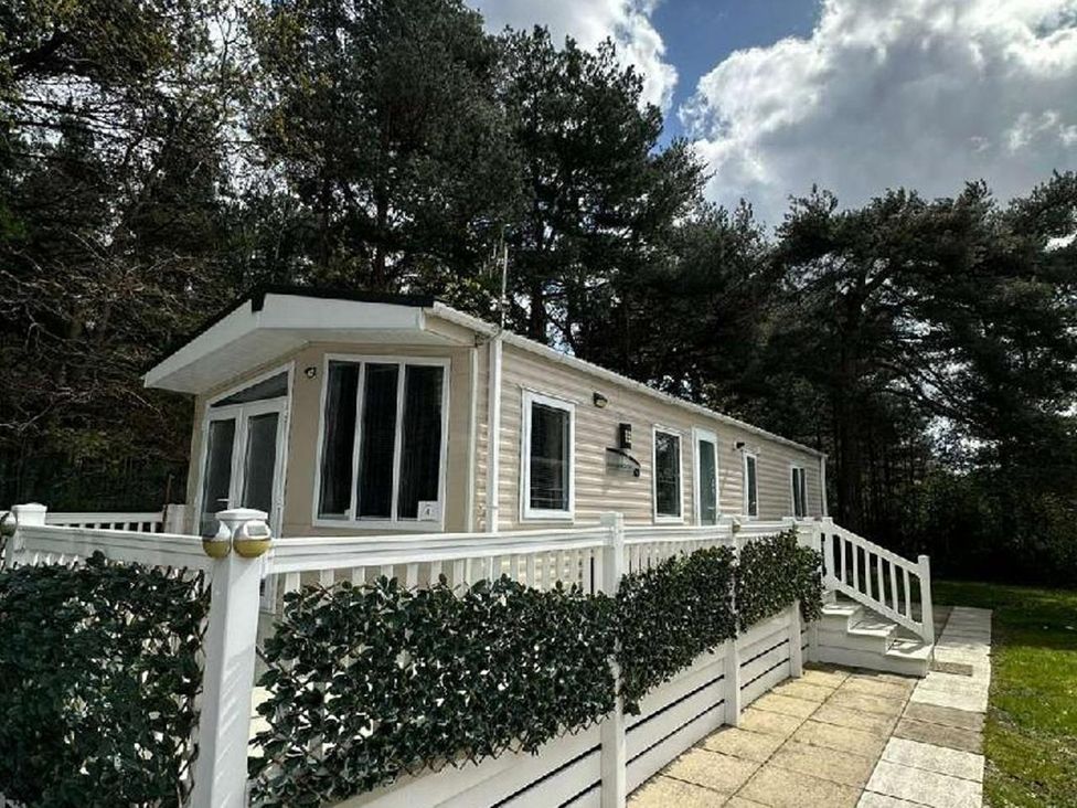 A cabin exterior with a staircase and patio at 2Bed Ringwood Cabin incl Park Pass SelfCheckin Saint Leonards near Ferndown