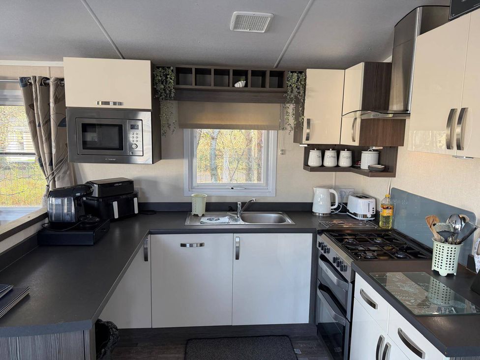 A kitchen with a microwave and cooking appliances at 2Bed Ringwood Cabin incl Park Pass SelfCheckin Saint Leonards near Ferndown
