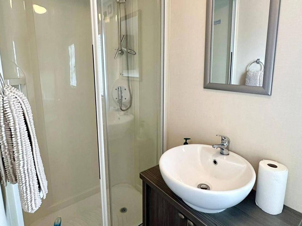A bathroom with a shower and sink at 2Bed Ringwood Cabin incl Park Pass SelfCheckin Saint Leonards near Ferndown