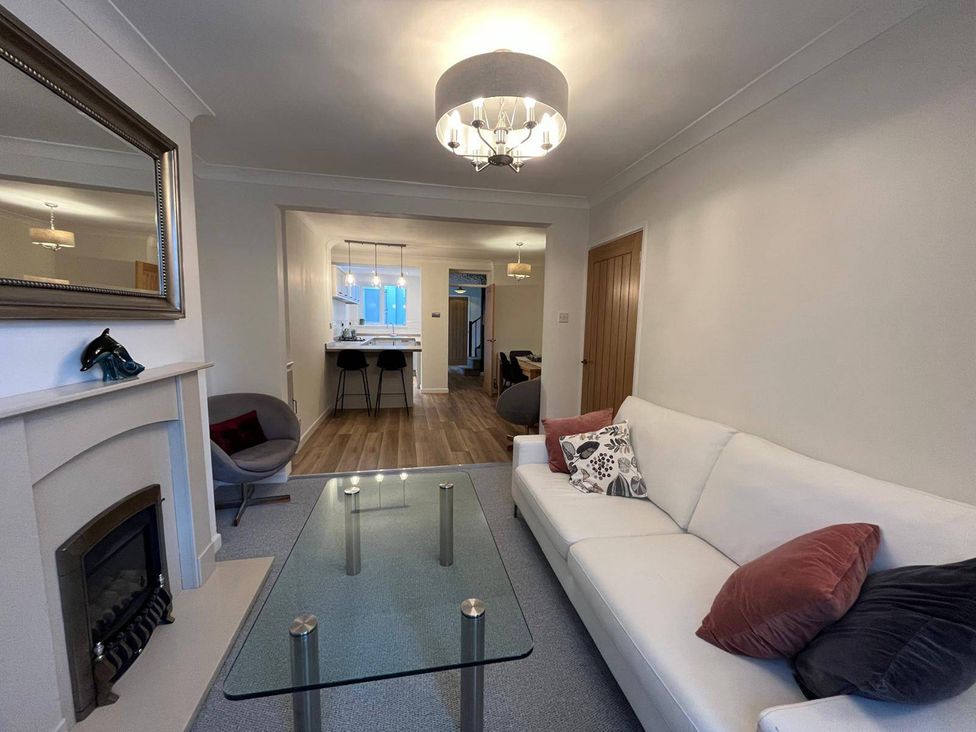 A living room with a sofa and coffee table at Charming 3Bed Cottage Private Garden Parking in Torquay