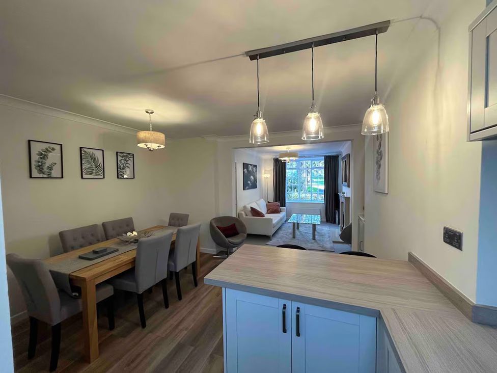 A dining room with a table and chairs visible at Charming 3Bed Cottage Private Garden Parking Torquay