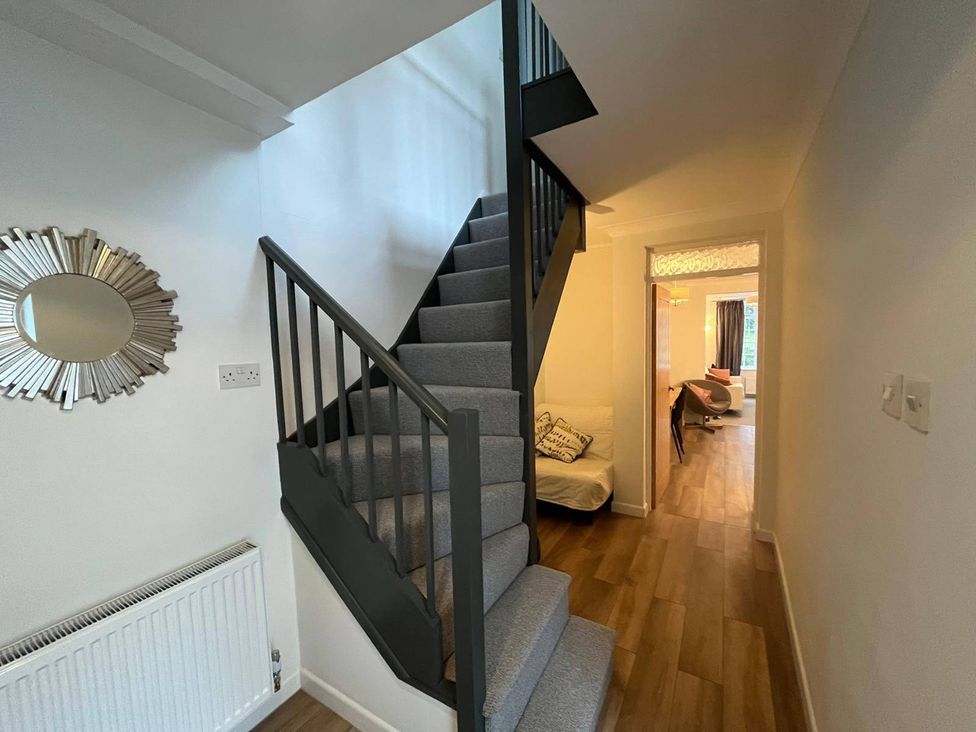 A staircase in a hallway at Charming 3Bed Cottage  Private Garden Parking in Torquay