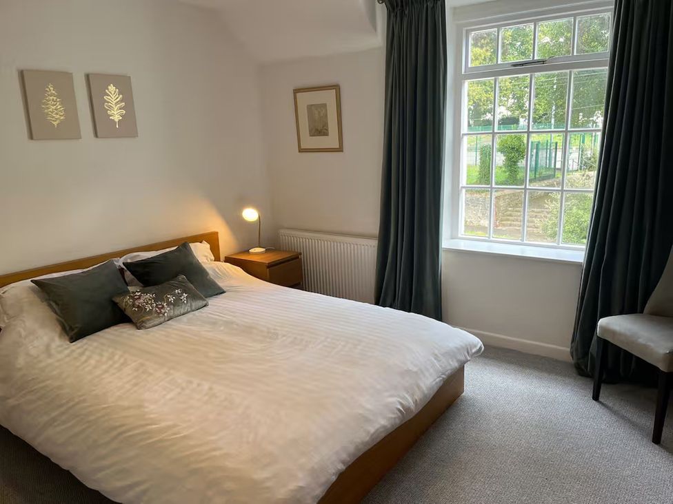 A bedroom with a bed and window at Charming 3Bed Cottage Private Garden Parking in Torquay
