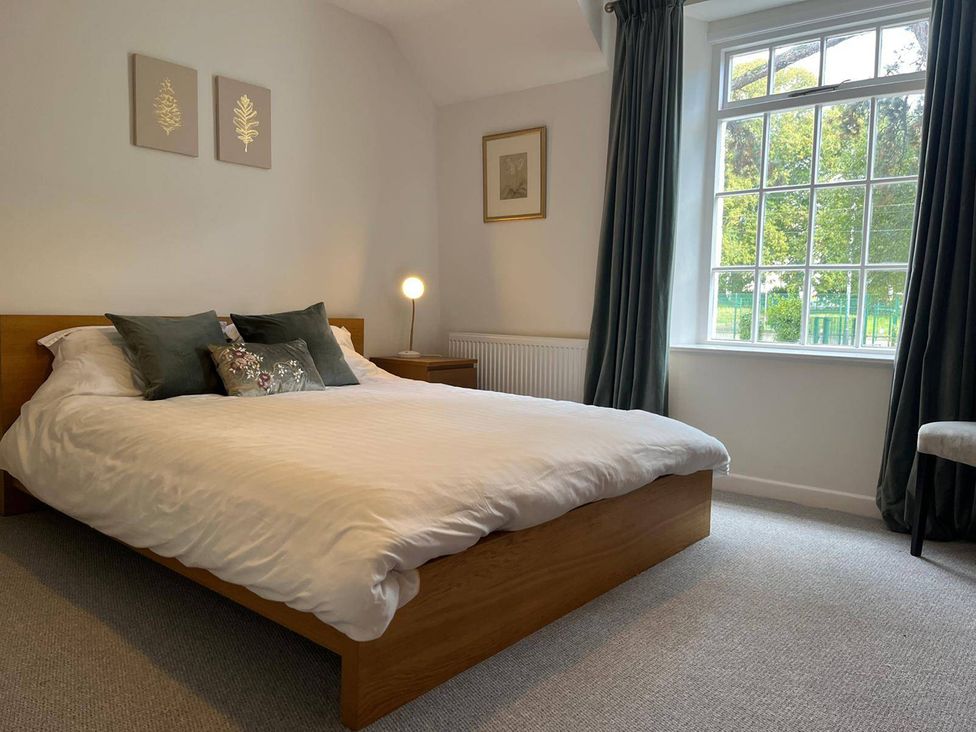 A bedroom with a bed and window at Charming 3Bed Cottage Private Garden Parking in Torquay