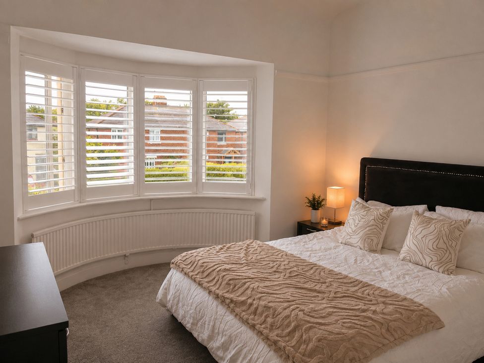 A bedroom with a bed and window at 3Bed House Sleeps 7 Parking Garden Pets Ok Lytham St. Annes