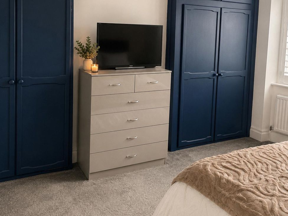 A bedroom with a television on a dresser and a closet at 3Bed House Sleeps 7 Parking Garden Pets Ok Lytham St. Annes