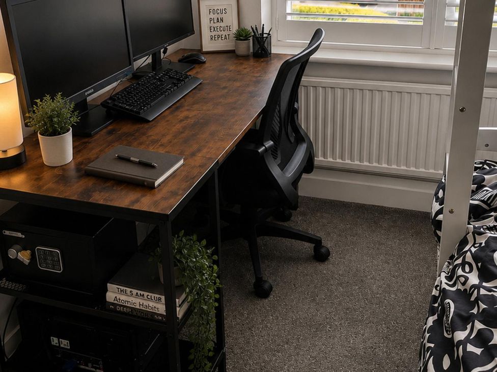 An office with a desk, computer monitors, and a chair at 3Bed House Sleeps 7 Parking Garden Pets Ok in Lytham St. Annes