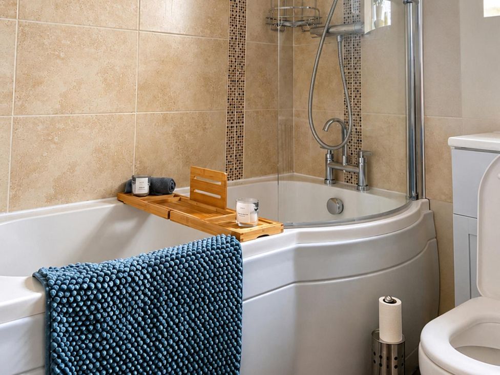 A bathroom with a bathtub and shower at 3Bed House Sleeps 7 Parking Garden Pets Ok Lytham St. Annes