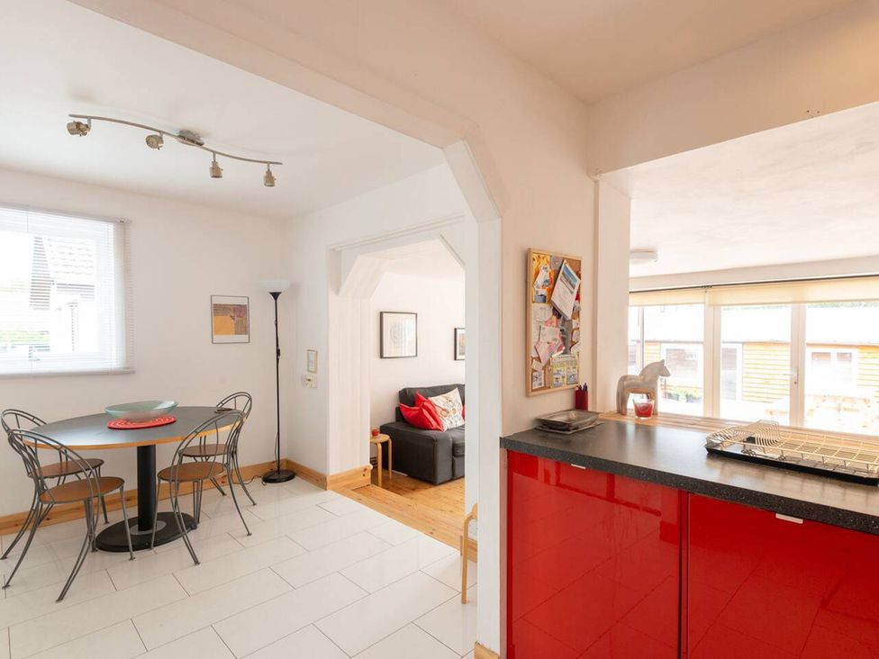 A kitchen with a table and chairs at 2bed Cottage Private garden Freeparking in Aviemore