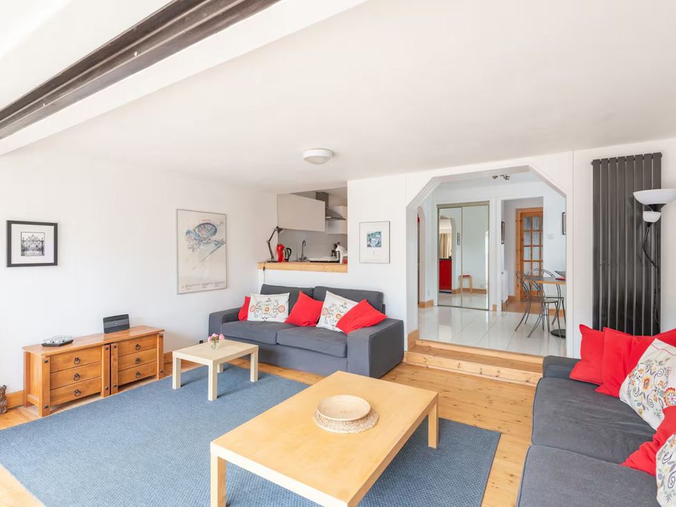 A living room with a sofa and coffee table at 2bed Cottage Private garden Freeparking in Aviemore