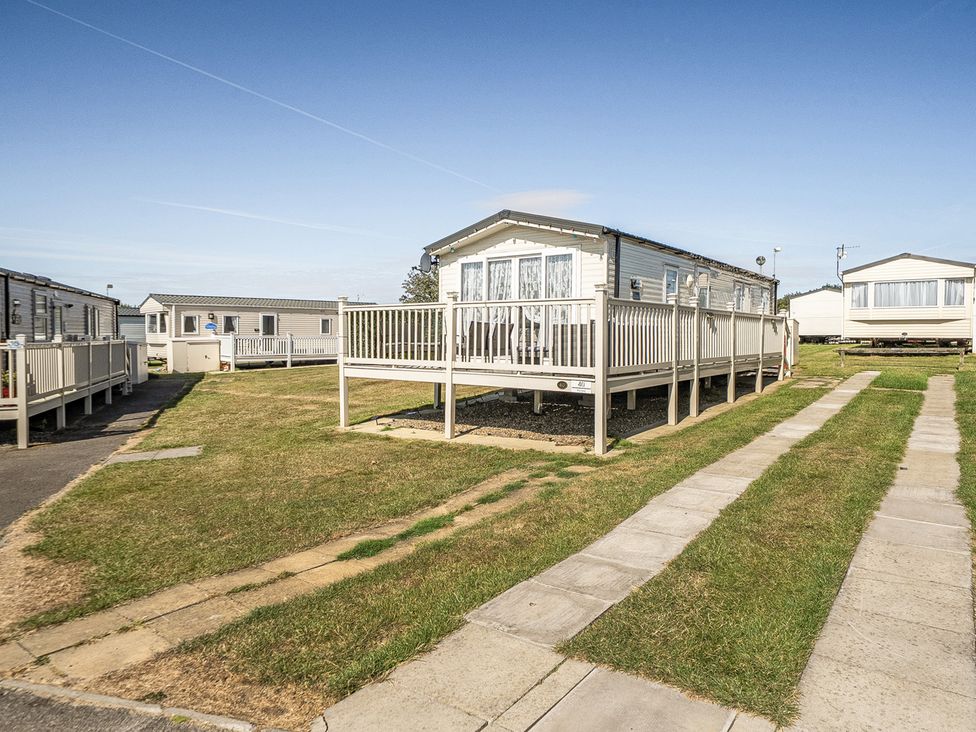 A static caravan with decking in an outdoor area at Cayton Bay Holiday Park Kestrel40 in Cayton Bay