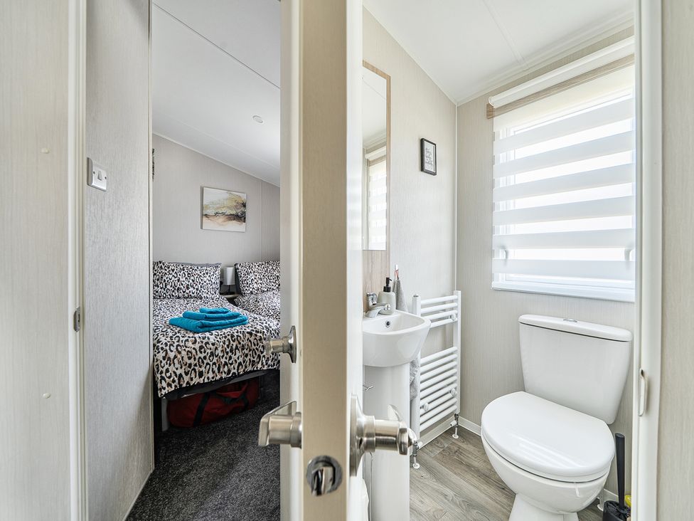 A bathroom with a sink and toilet at Cayton Bay Holiday Park Kestrel40 Cayton Bay