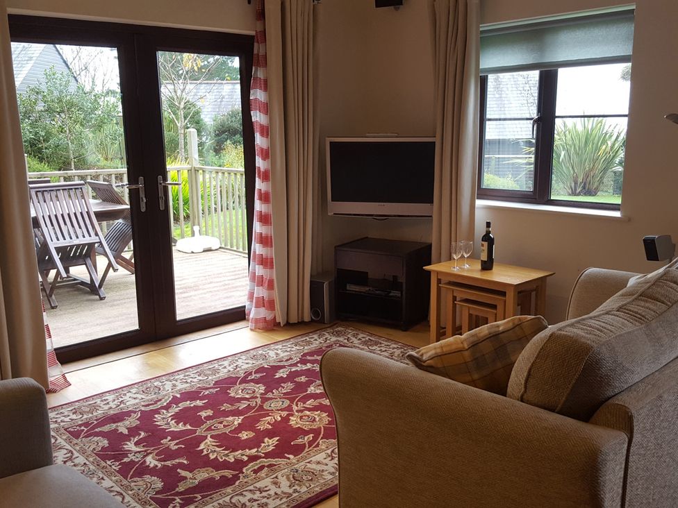 A living room with a sofa and a television at 2bed sleeps4 pool freeparking Trenythonestate Near Par