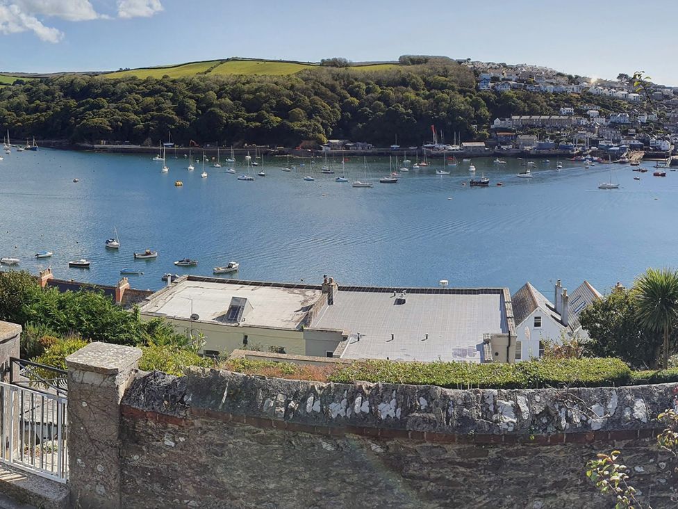 A view of boats on water with hills and buildings at 2bed sleeps4 pool freeparking Trenythonestate Near Par