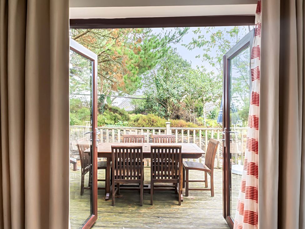An outdoor area with a table and chairs at 2bed sleeps4 pool freeparking Trenythonestate Near Par