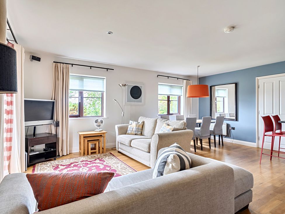 A living room with sofa and dining area at 2bed sleeps4 pool freeparking Trenythonestate near Par