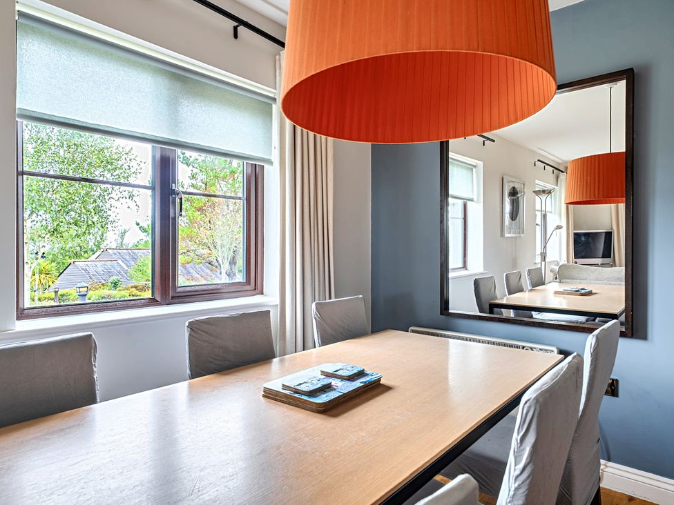 A dining room with table and chairs at 2bed sleeps4 pool freeparking Trenythonestate near Par