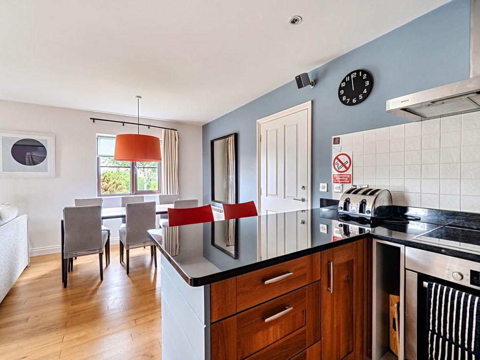 A kitchen with a dining area at 2bed sleeps4 pool freeparking Trenythonestate Near Par