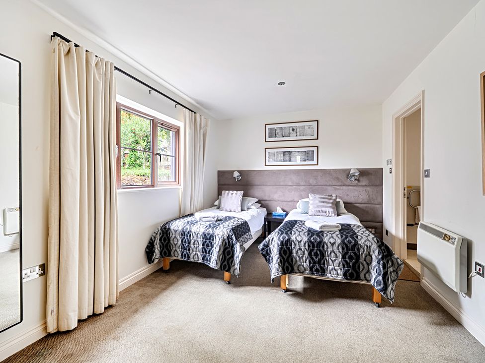 A bedroom with two beds and a window at 2bed sleeps4 pool freeparking Trenythonestate Near Par